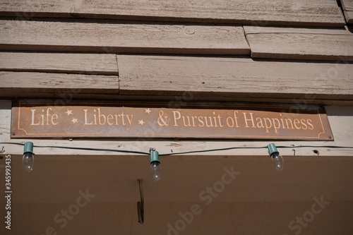Photography A rusty old sign in the USA showing Life Liberty & Pursuit of Happiness