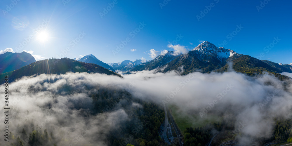 sun while sunrise with morning mist and mountain thaneller at tirol