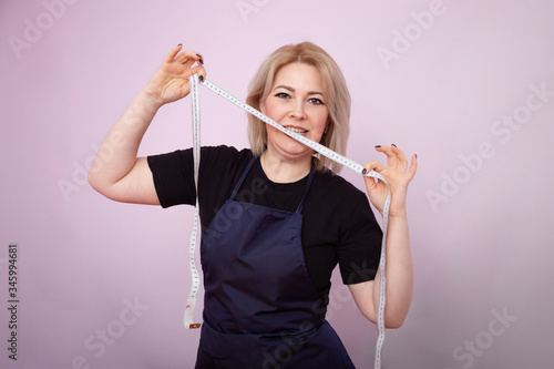 attractive woman holds a centimeter in her hands and holds it to her mouth