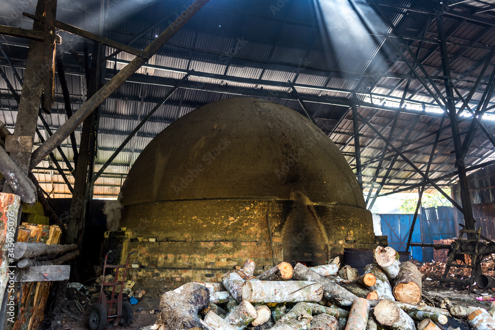 traditional charcoal kiln with charcoal under production with mangrove
