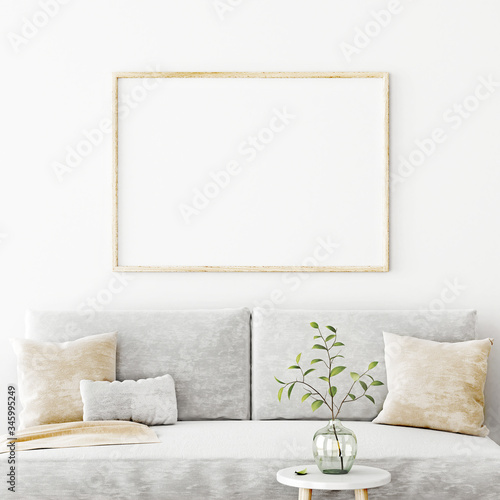 Poster mockup with horizontal frame hanging on the wall in living room interior with sofa, beige pillows and green branch in glass vase on empty white background. 3D rendering, illustration.