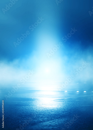 Blue blurred background of the night sky  reflection of the lights of the night city on the pavement. Smoke  fog  smog.