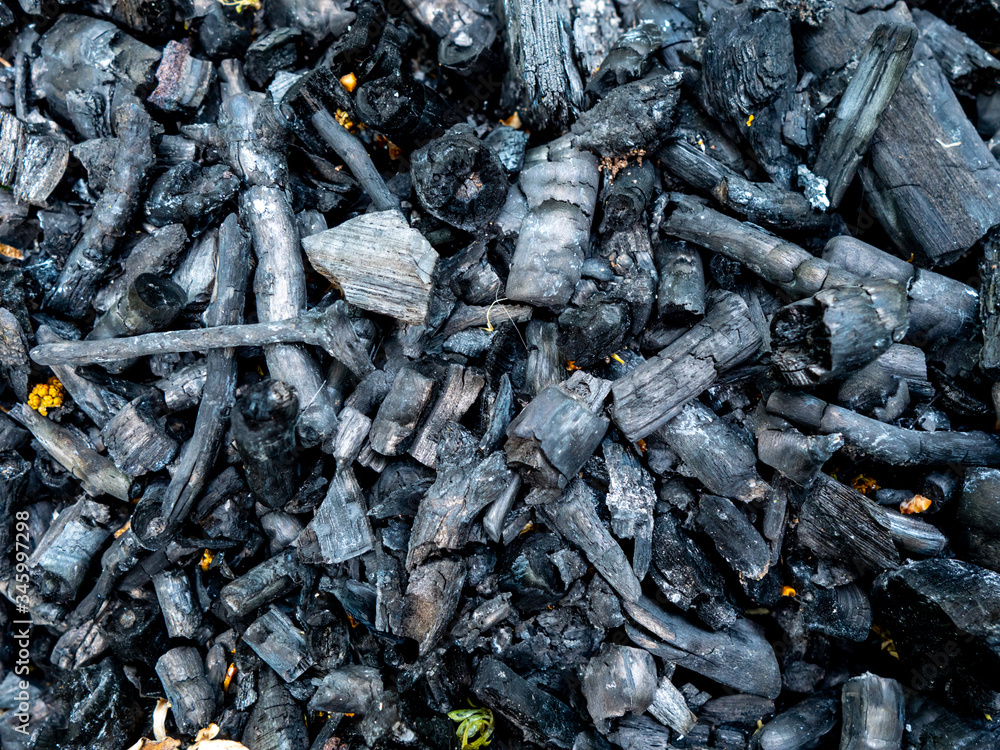 Charcoal texture after a bonfire. Black coals background Charcoal texture after a bonfire. Black coals background