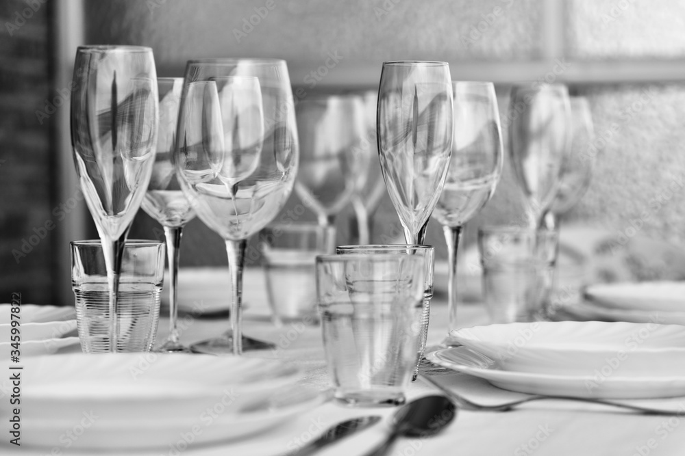 Table settings with diverse glassware and tableware closeup Table settings with diverse glassware and tableware closeup