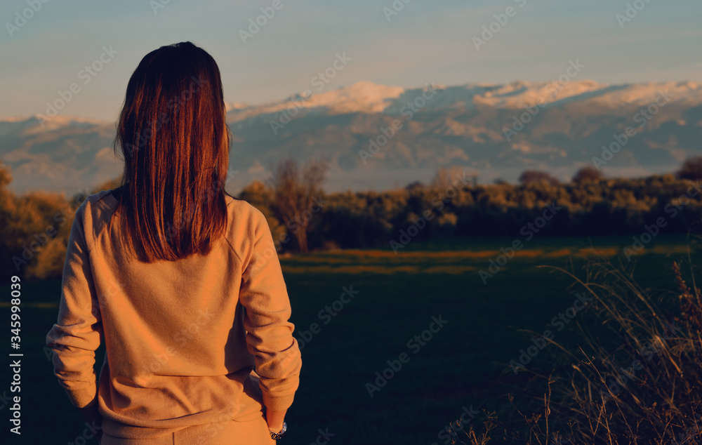Fototapeta premium Rearview woman enjoy Sierra Nevada ridge mountains view. Spain