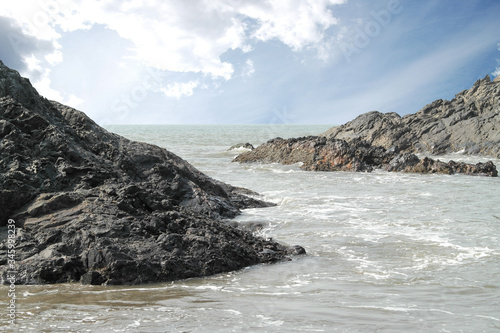 Rocks from volcanic rock on ocean beach