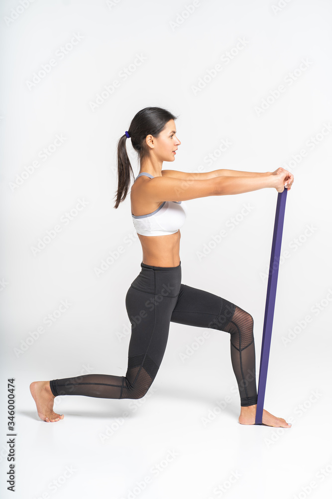Woman doing pilates exercises with elastic Woman doing pilates exercises with elastic