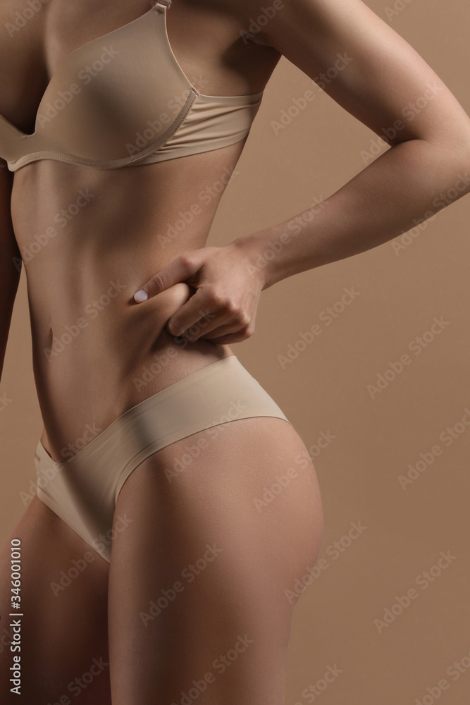 Thin woman shows fold of fat Thin woman shows fold of fat