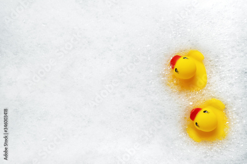 Fotografie High Angle View of yellow rubber duck in bath swimming in foam water