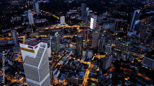 Photography Aerial view of city skyline at the developed corporative area of Kuala Lumpur in Malaysia, skyscrapers, lights on streets during the night
