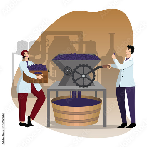 Man and woman winemakers in work uniform crumple grapes on industrial masher against the background of the winery shop