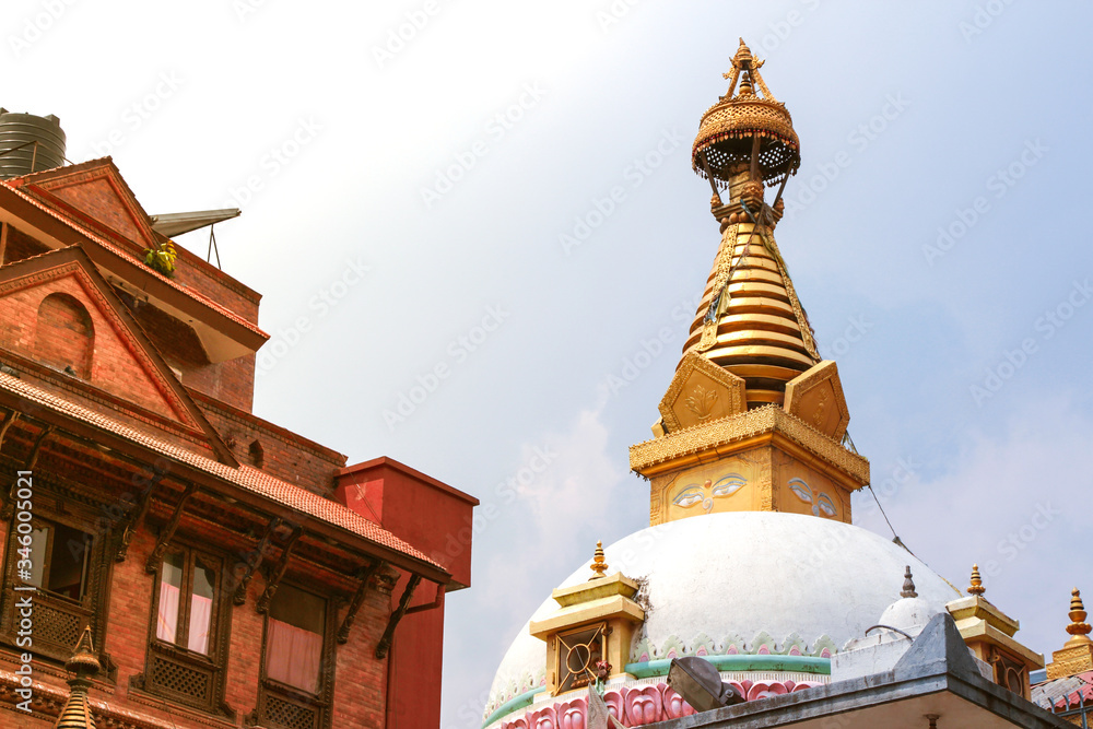 Fototapeta premium View of traditional gold colored stupa of tibetan buddhist Drugon Jangchu Monastery in Thamel district of Kathmandu city. Religious architecture theme.