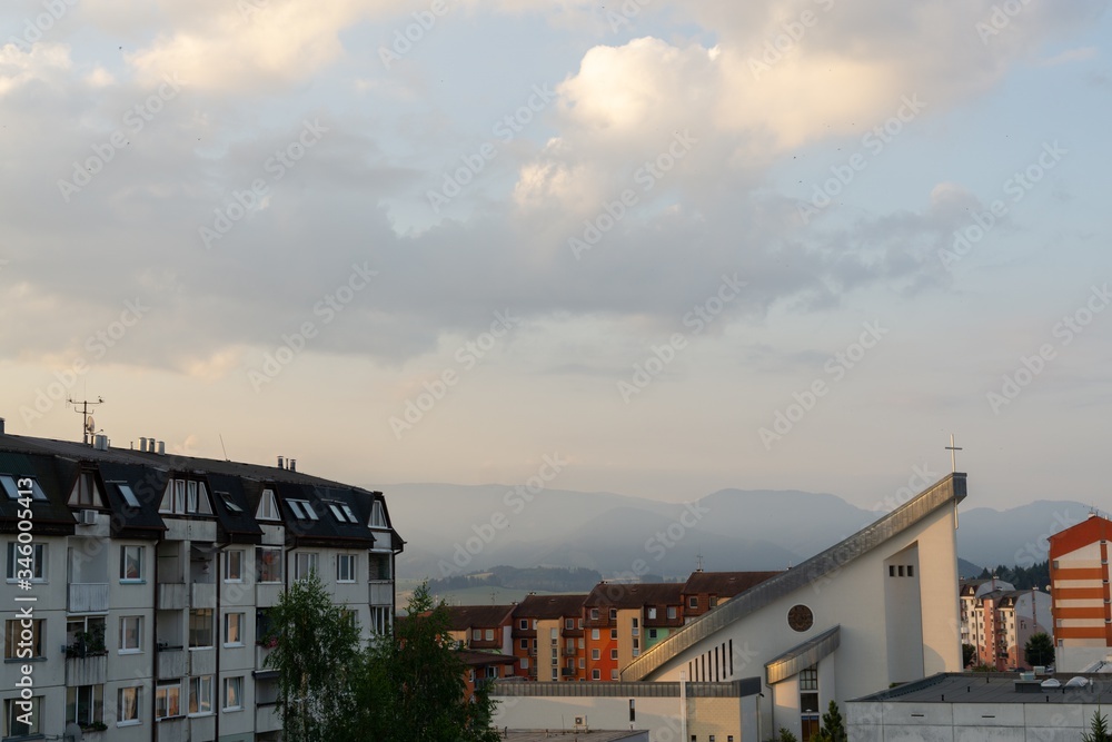 Sunrise and sunset, beautiful clouds over the meadow, hills and buildings in the town. Slovakia Sunrise and sunset, beautiful clouds over the meadow, hills and buildings in the town. Slovakia