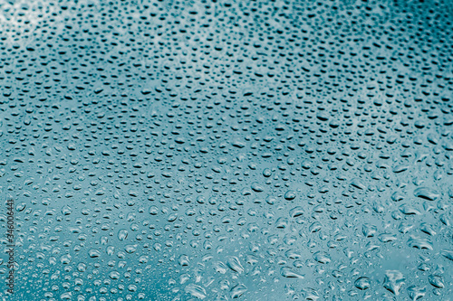 Blue and green raindrops on the glass