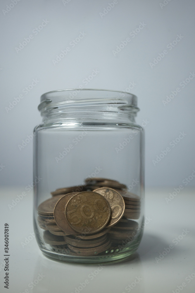 coins in a transparent bottle or jar coins in a transparent bottle or jar