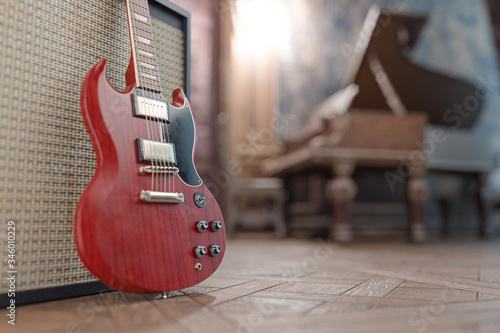 Fotografija Red electric guitar in a beautiful old room