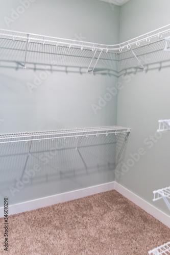 Tapeta Empty master bedroom walk-in closet with wire shelving