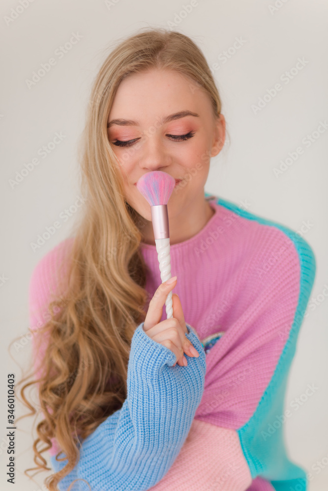 Portrait of beautiful young blonde girl with makeup in fashion clothes Portrait of beautiful young blonde girl with makeup in fashion clothes