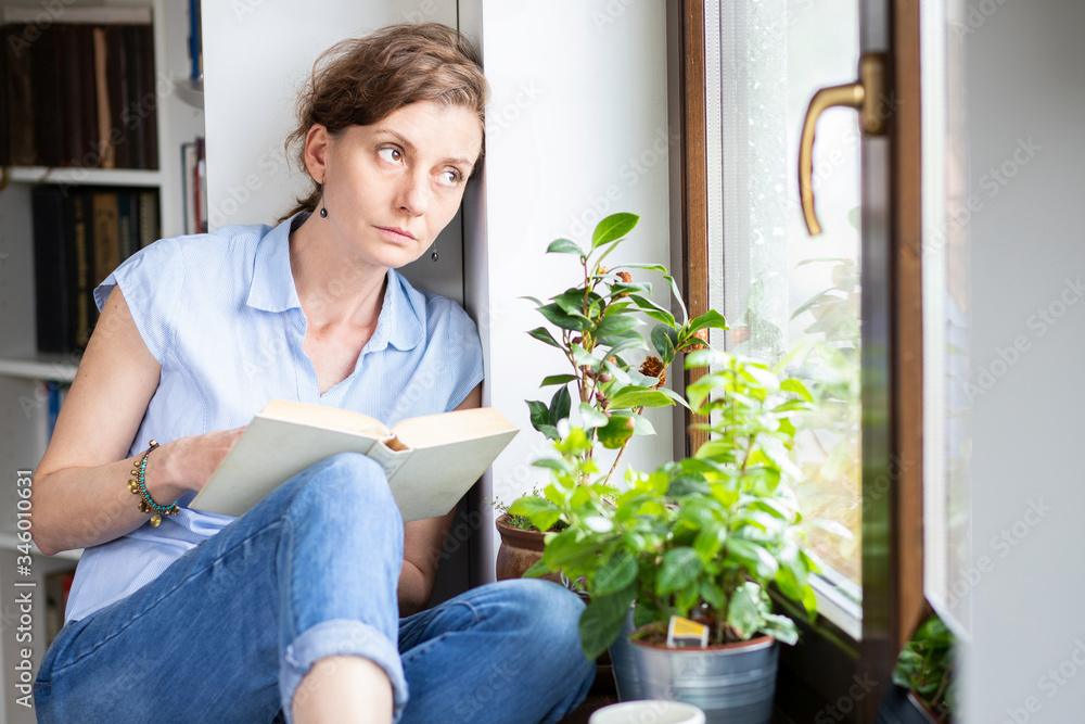 pensive woman working from home looking out on window thinking about future, relationship, career pensive woman working from home looking out on window thinking about future, relationship, career