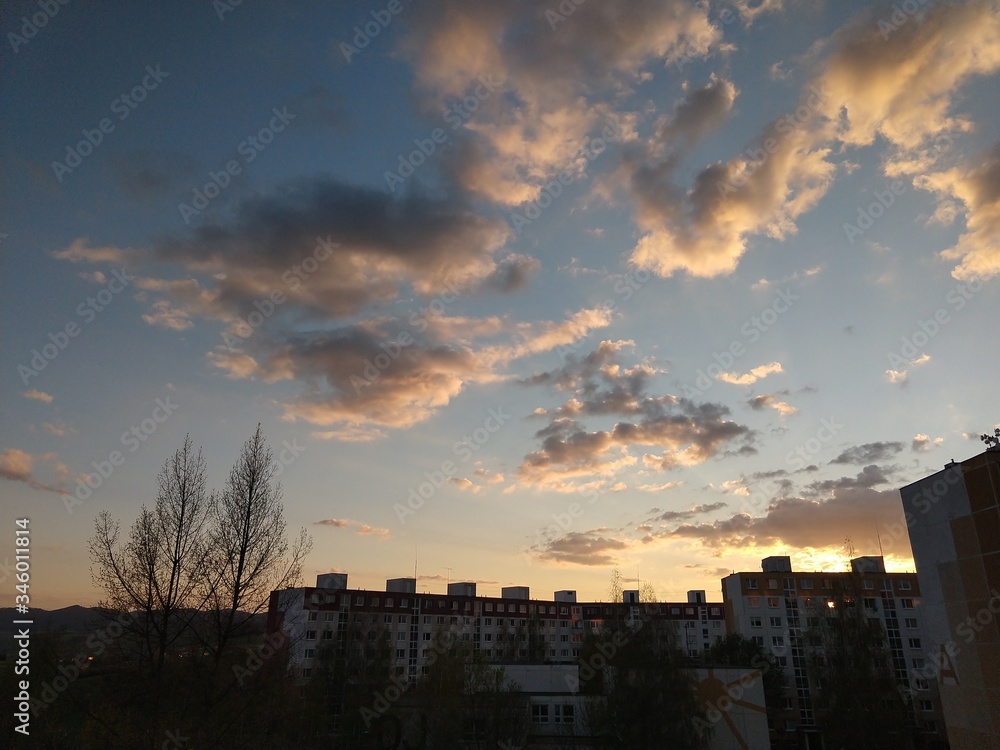 Sunrise and sunset, beautiful clouds over the meadow, hills and buildings in the town. Slovakia Sunrise and sunset, beautiful clouds over the meadow, hills and buildings in the town. Slovakia