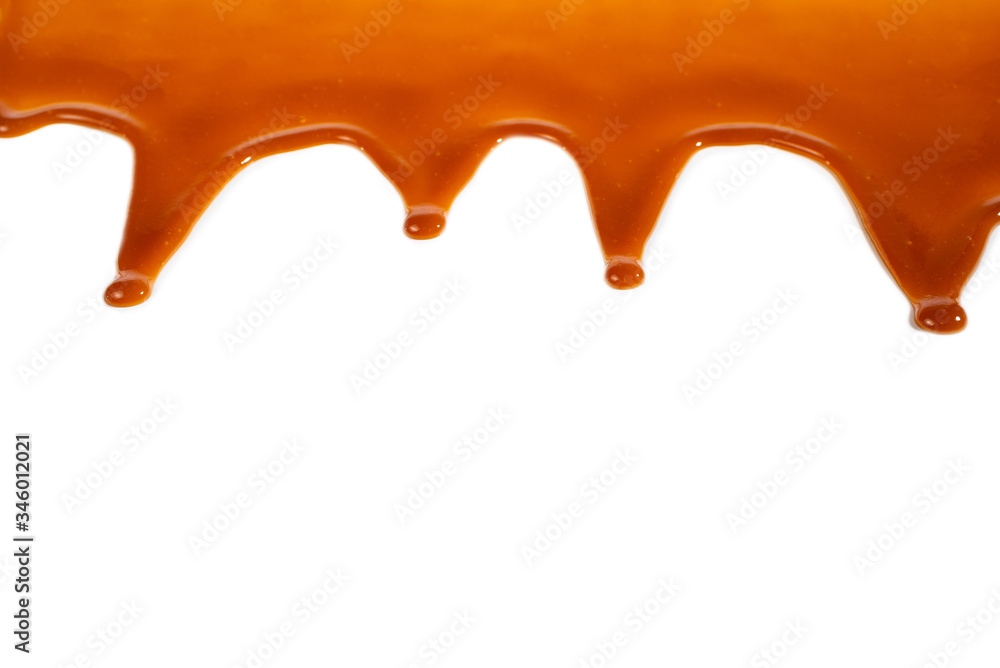 Fototapeta premium Background of flowing caramel sauce isolated on white.