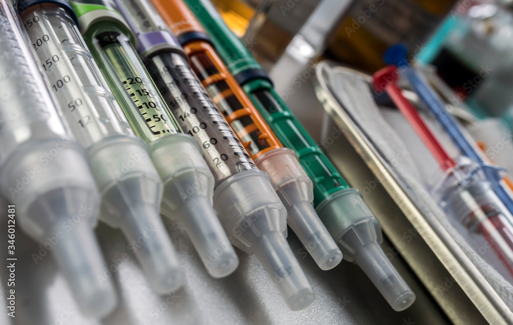 Syringes of insulin medication next to medicine vials prepared in hospital, conceptual image Syringes of insulin medication next to medicine vials prepared in hospital, conceptual image