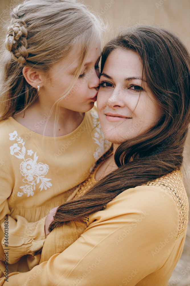 Young mother hugs her daughter. Mother's Day Young mother hugs her daughter. Mother's Day