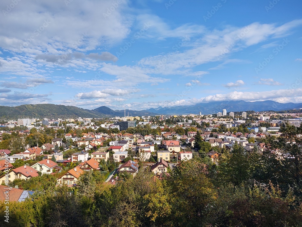 Sunrise and sunset, beautiful clouds over the meadow, hills and buildings in the town. Slovakia