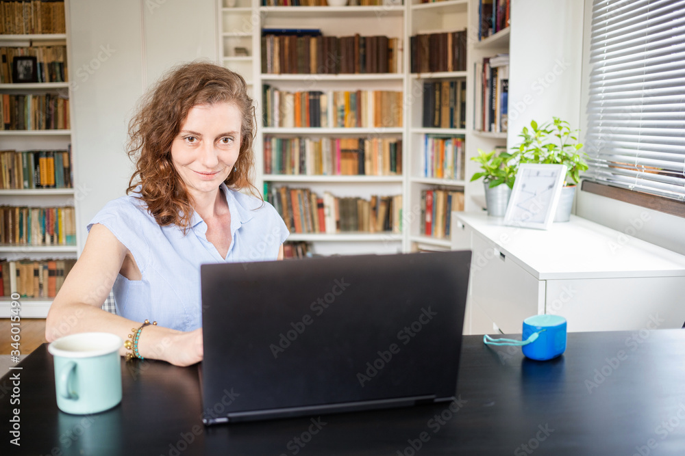 happy woman working on laptop in home office happy woman working on laptop in home office