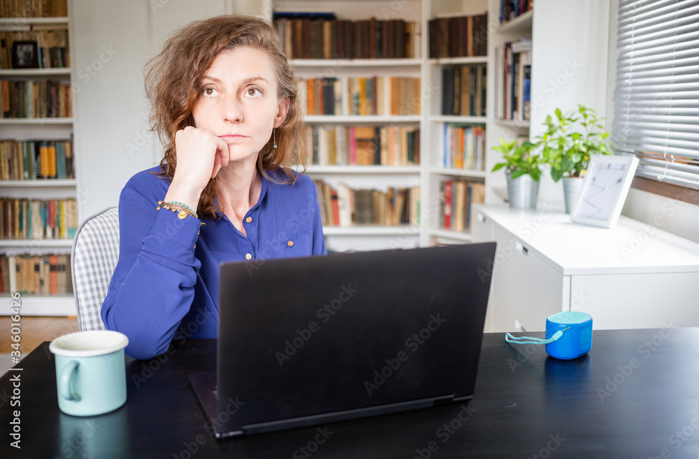 pensive woman working from home looking out on window thinking about future, relationship, career pensive woman working from home looking out on window thinking about future, relationship, career