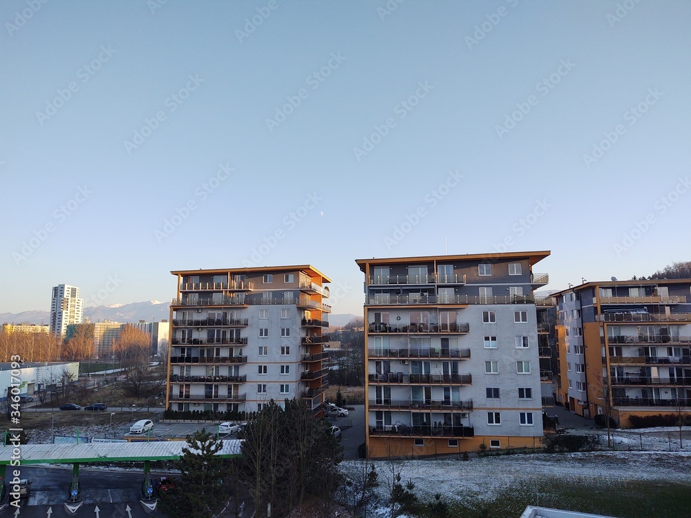 Sunrise and sunset, beautiful clouds over the meadow, hills and buildings in the town. Slovakia Sunrise and sunset, beautiful clouds over the meadow, hills and buildings in the town. Slovakia