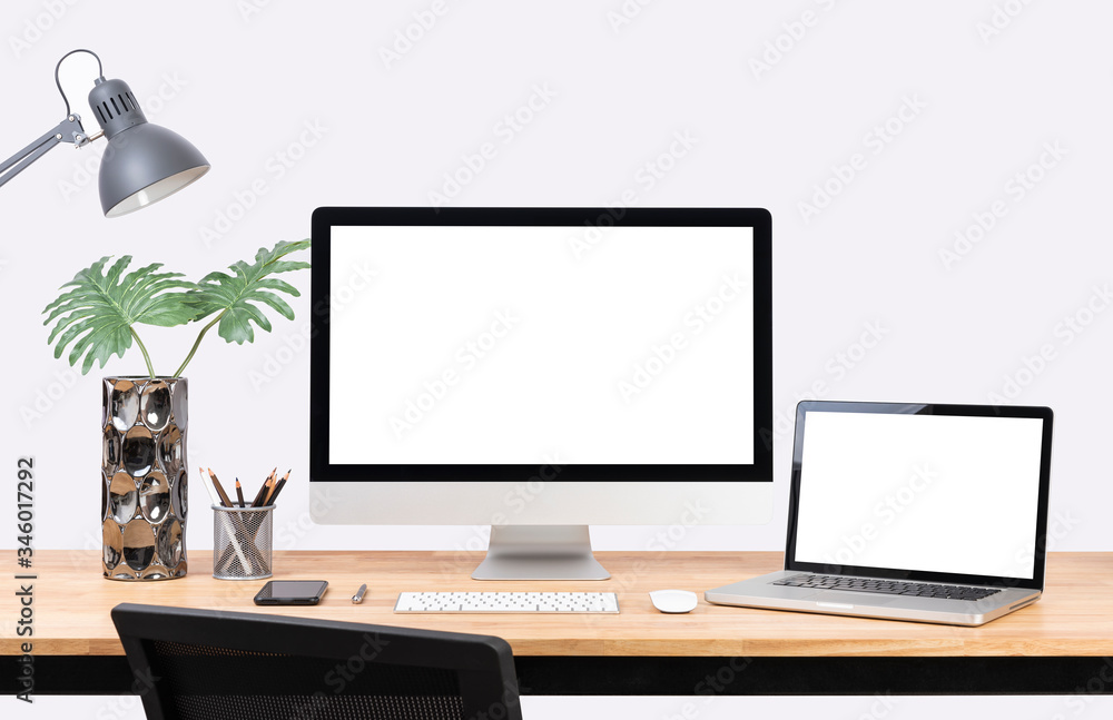 Mockup Blank screen desktop computer and decorations on wood table and white wall background.