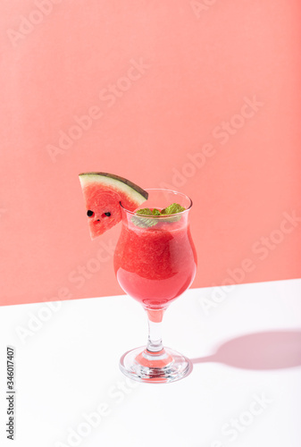 Fresh water melon juice and watermelon slice on color background. summer drink. photo