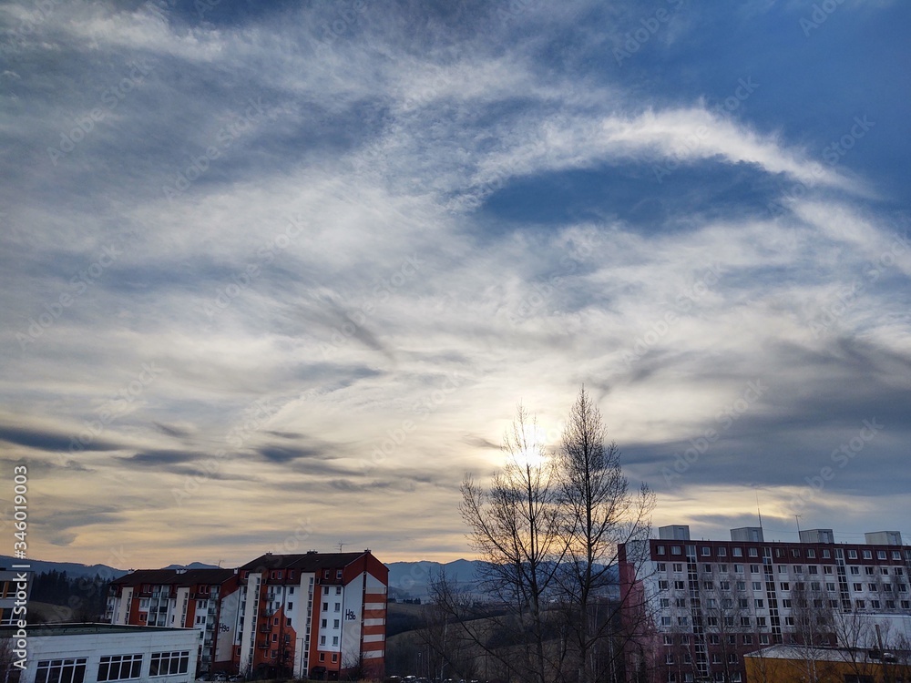 Sunrise and sunset, beautiful clouds over the meadow, hills and buildings in the town. Slovakia Sunrise and sunset, beautiful clouds over the meadow, hills and buildings in the town. Slovakia