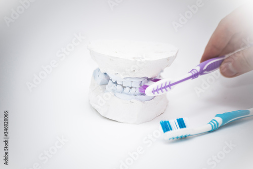 Oral care. Sweets destroying teeth and a toothbrush. Person s choice
