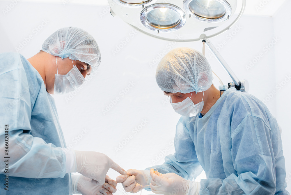 Operation in a modern operating room close-up, emergency rescue and resuscitation of the patient. Medicine and surgery Operation in a modern operating room close-up, emergency rescue and resuscitation of the patient. Medicine and surgery