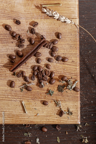 Coffee beans and cinnamon lie on a cutting board