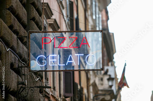 Italian bar signboard outside closeup with text reading Pizza Gelato.