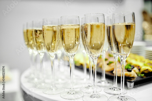 crystal clear wine glasses with chilled expensive champagne stand on a table 