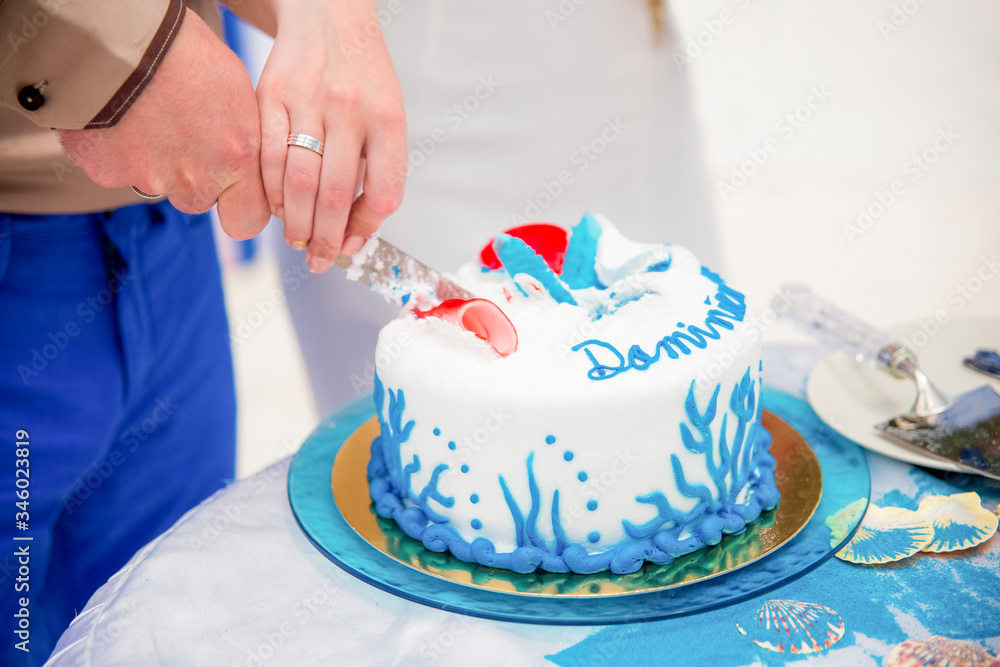 Tropical wedding cake for bride and groom to cut during destination wedding marriage outdoor ceremony on the sandy beach in Dominican republic Tropical wedding cake for bride and groom to cut during destination wedding marriage outdoor ceremony on the sandy beach in Dominican republic