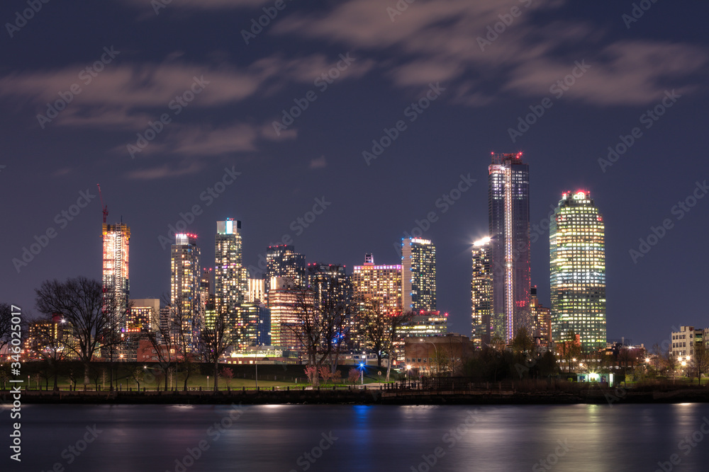View on Queens skyline at night from East river with long exposure