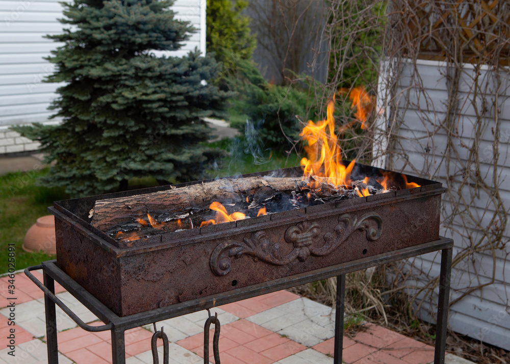 chargrill with a flame in the garden of russian country house