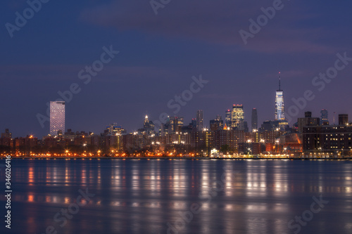 Downtown Manhattan view from East river during sunrise with long exposure