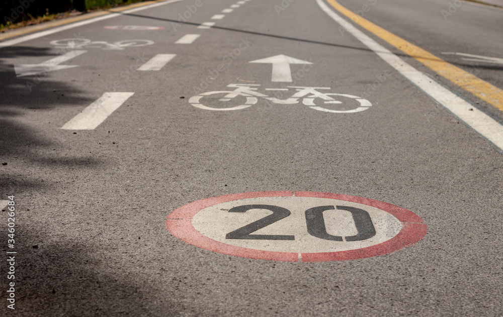 Fototapeta premium bicycle and speed limit signs on asphalt path