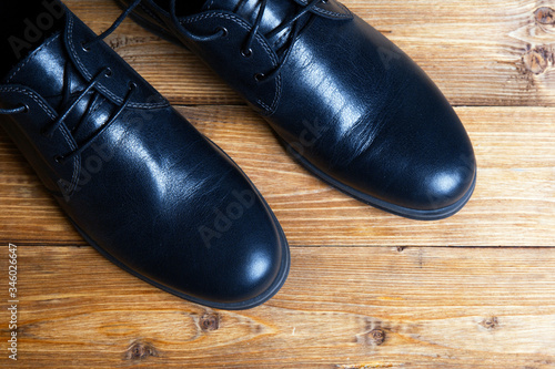 Men's black shoes on a wooden table  © ivanchik29