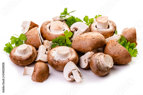 Brown champignons and parsley. Isolate on white background