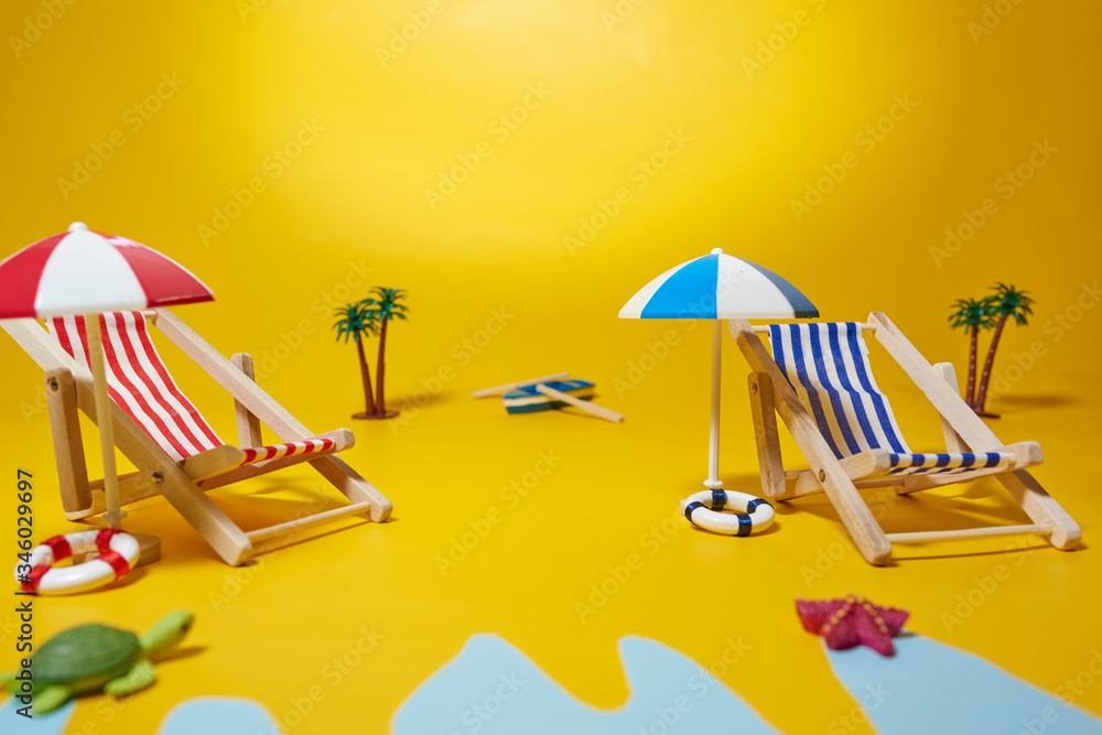 Beach hammocks with a yellow background. Concept beach photography.