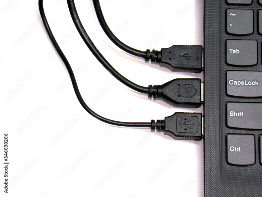 Three USB cords connected to a laptop Three USB cords connected to a laptop