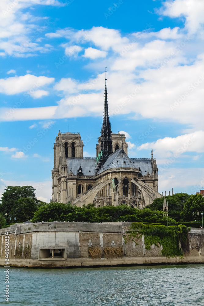 Notre Dame Cathedral on a background of blue sky with clouds.