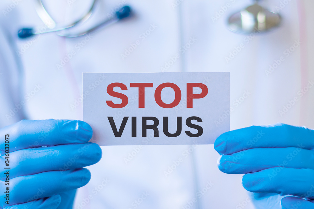 Stop virus text on card and hands holding it. Healthcare or prevention concept. Stop virus text on card and hands holding it. Healthcare or prevention concept.